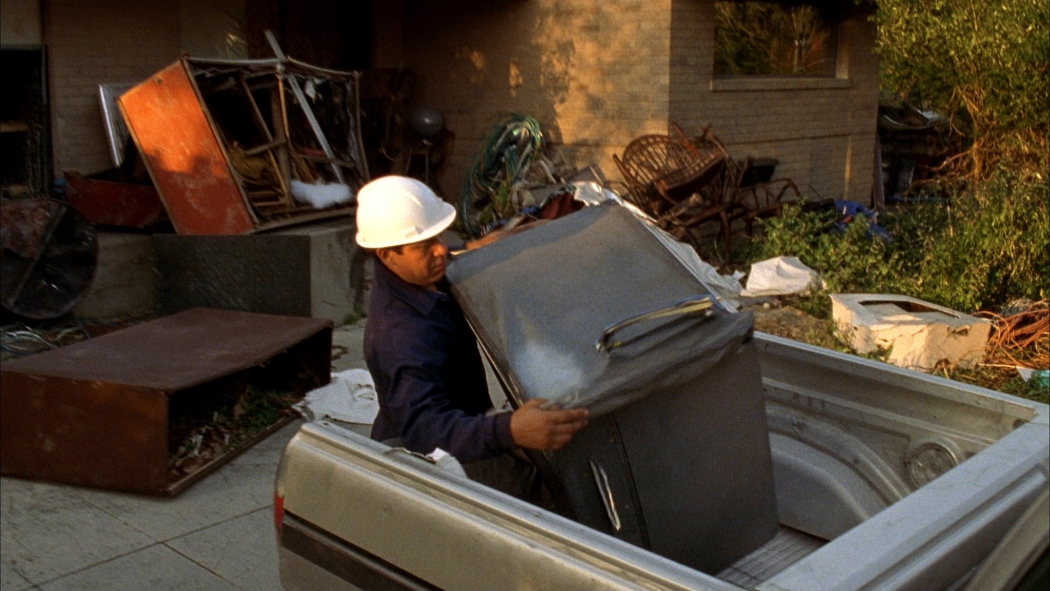 Loading an old appliance into the truck during a junk haul